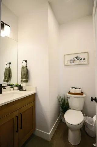 Bathroom with vanity and dark wood-type flooring