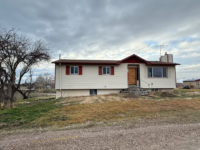 View of front of home featuring entry steps and a chimney