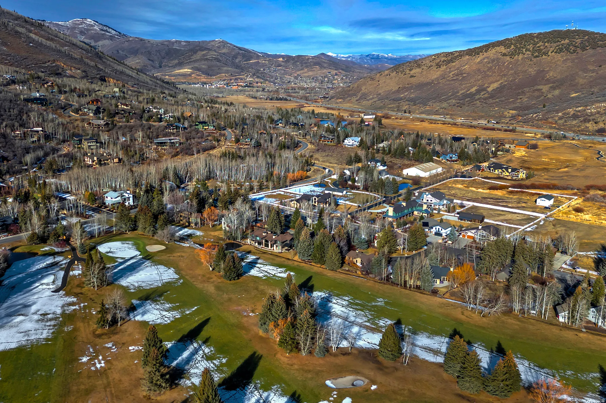 Aerial view of property's location featuring a mountainous background