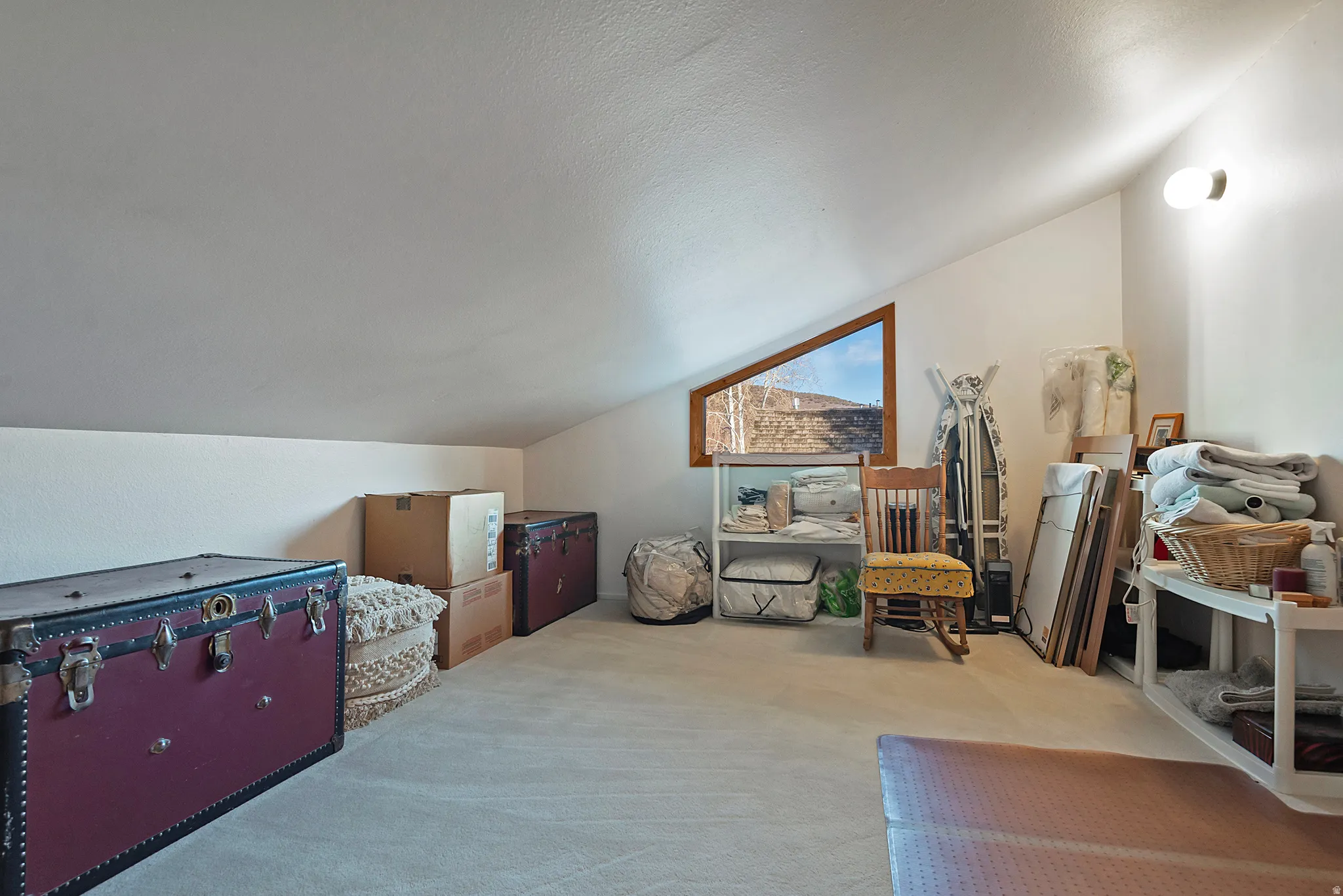 Bonus room featuring lofted ceiling, carpet floors, and a textured ceiling