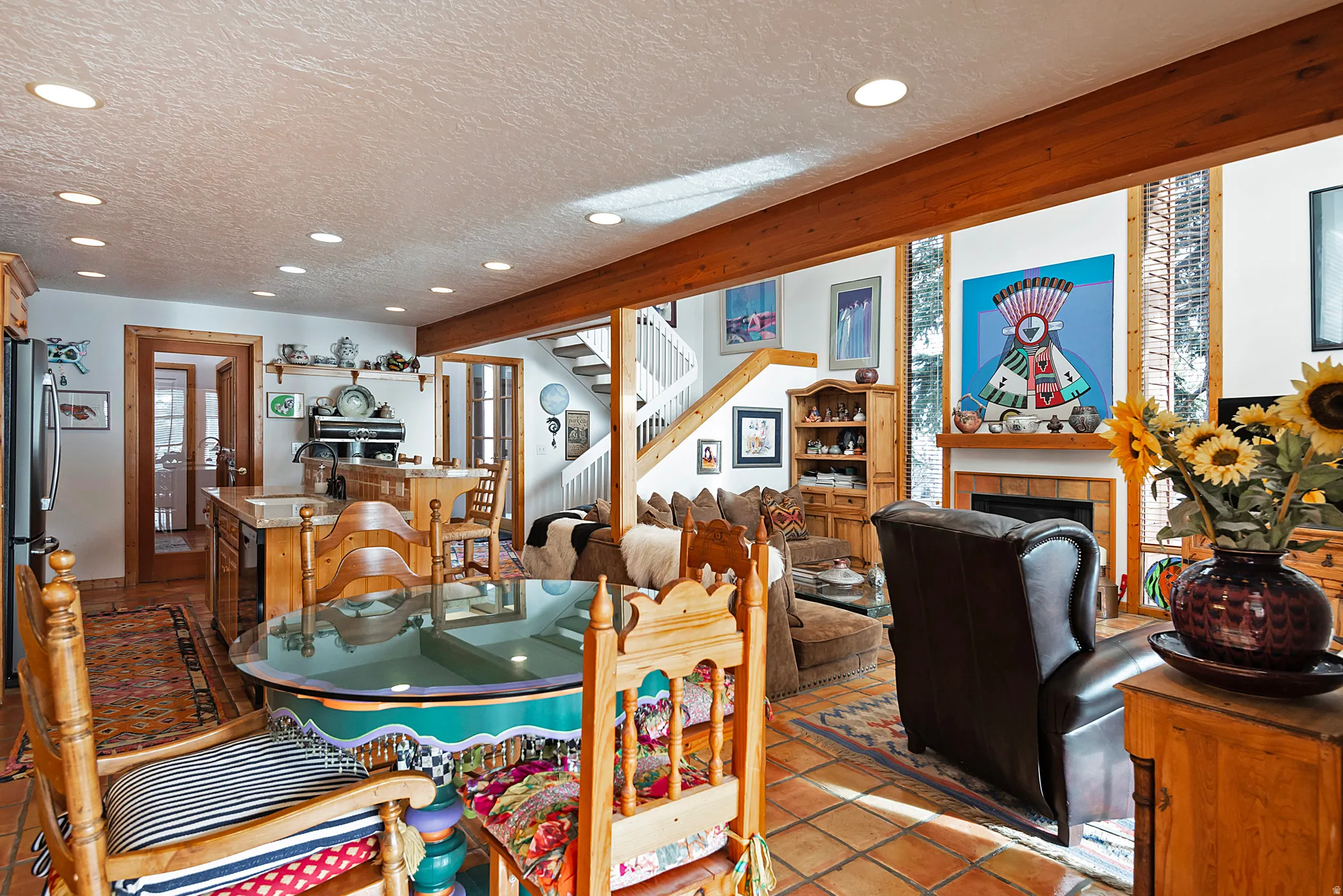 Dining room featuring recessed lighting, a tile fireplace, a textured ceiling, light tile patterned floors, and stairs