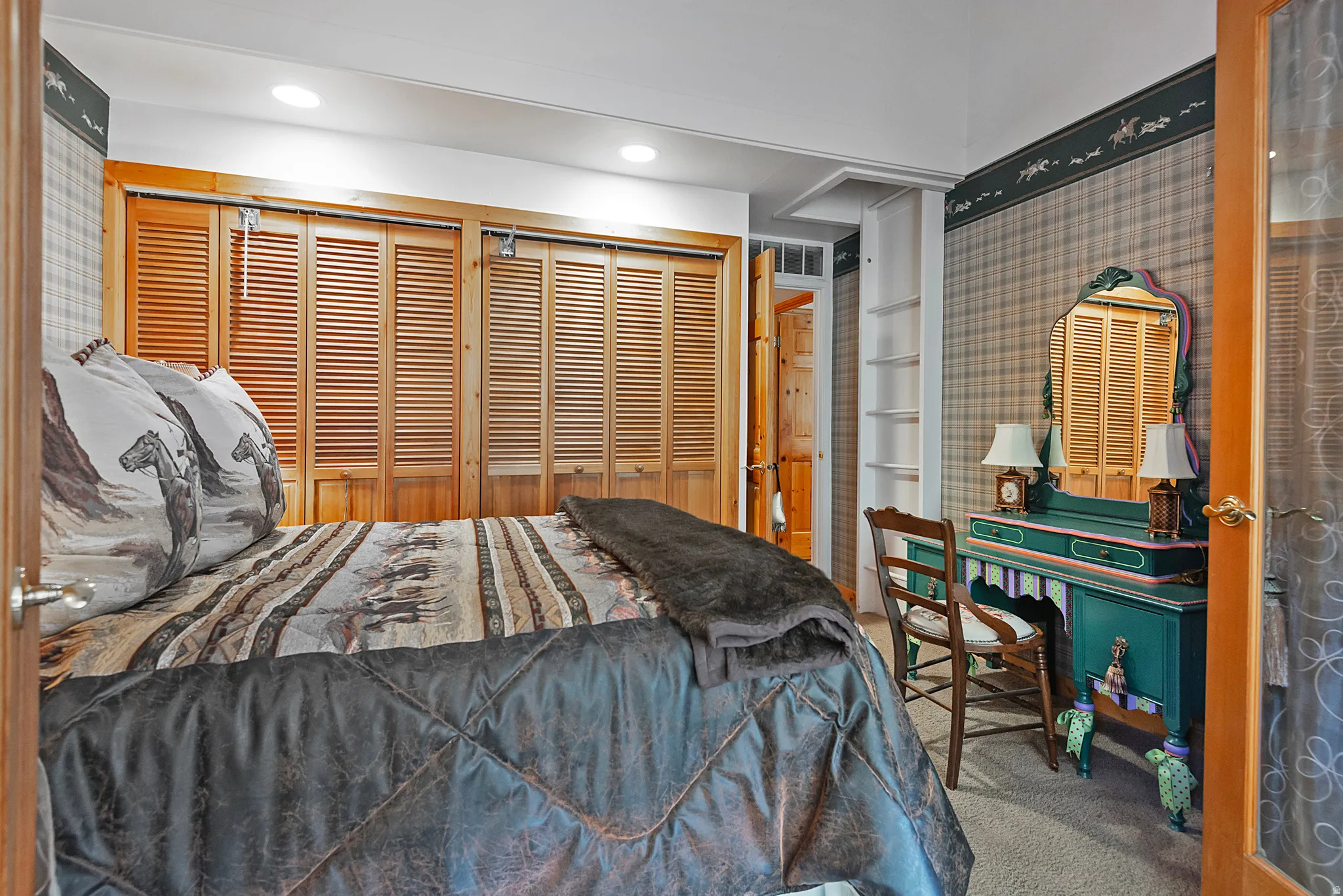 Carpeted bedroom featuring two closets
