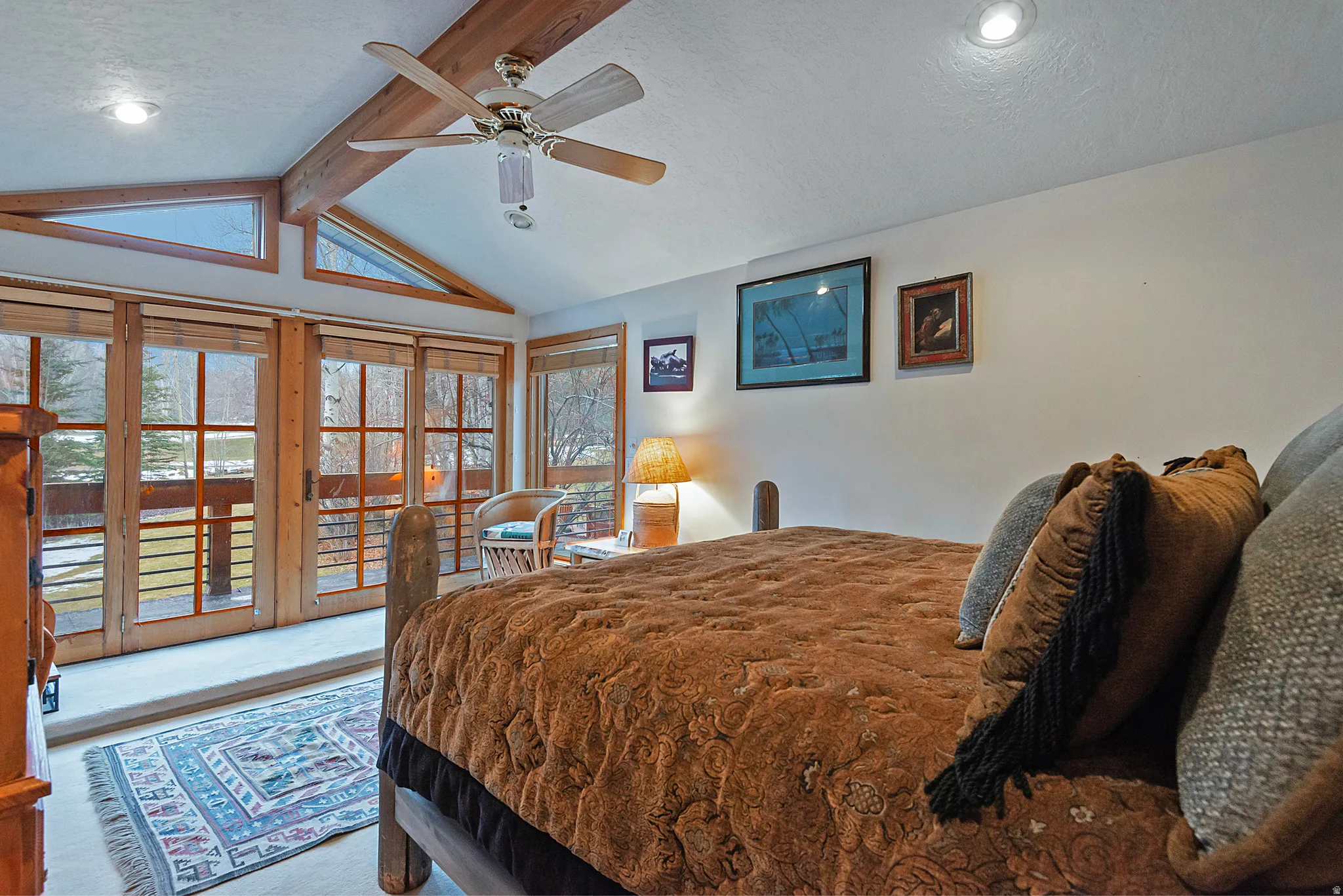 Bedroom featuring access to exterior, a textured ceiling, and a ceiling fan