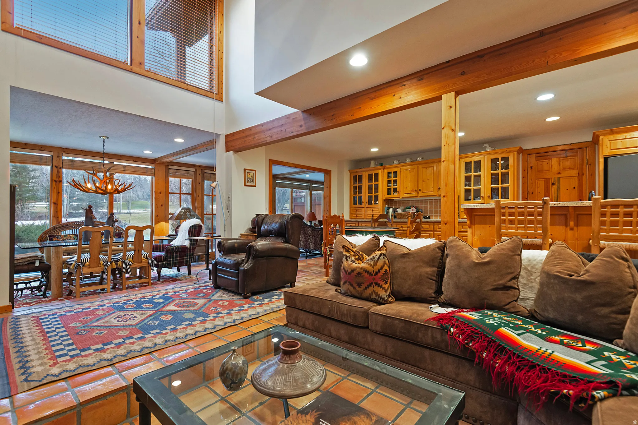 Tiled living area featuring a chandelier, recessed lighting, and beamed ceiling
