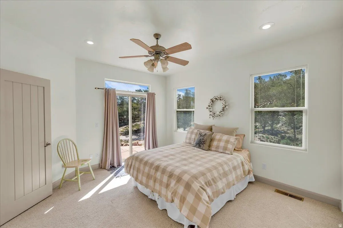 Bedroom featuring access to exterior, carpet flooring, a ceiling fan, and recessed lighting