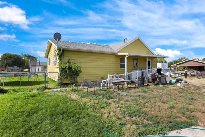 Rear view of house featuring a trampoline