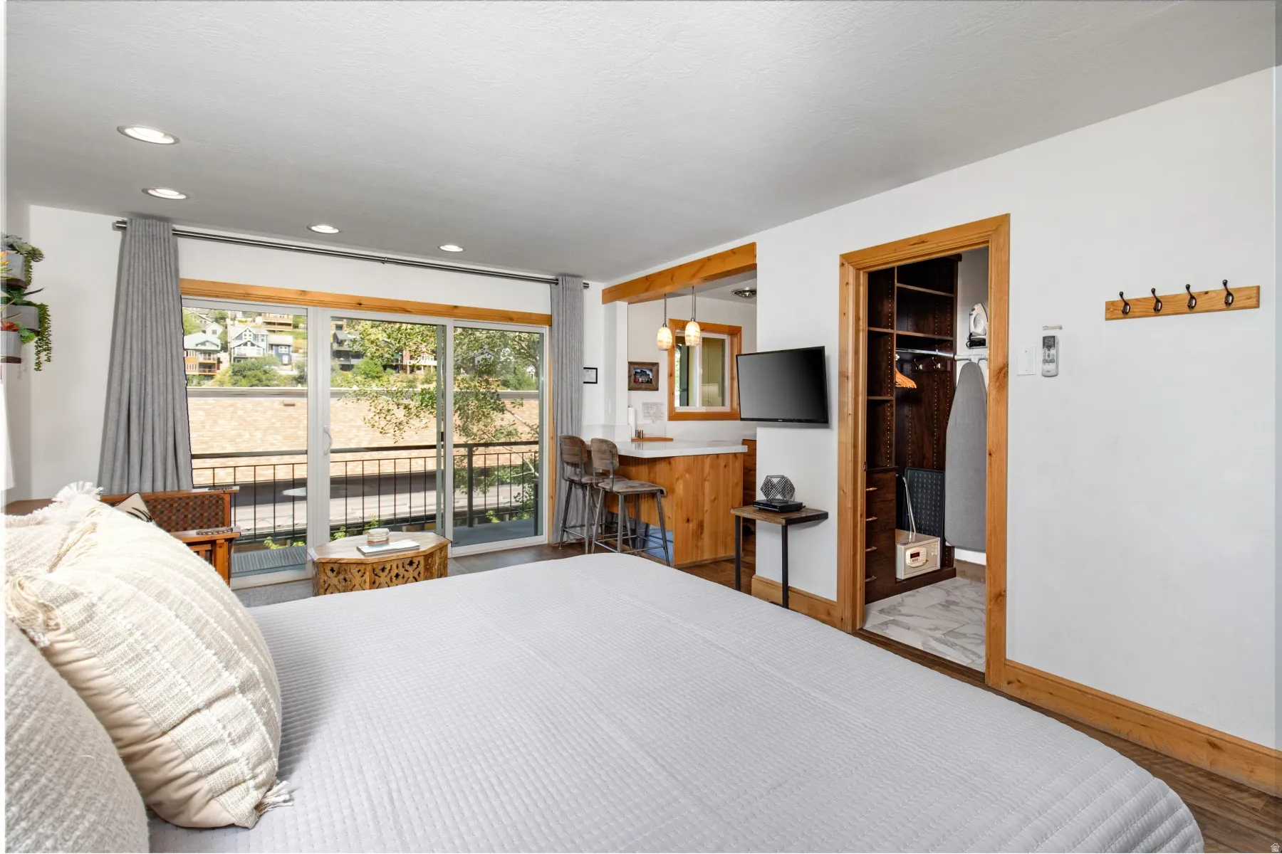 Bedroom with access to outside, recessed lighting, and a spacious closet