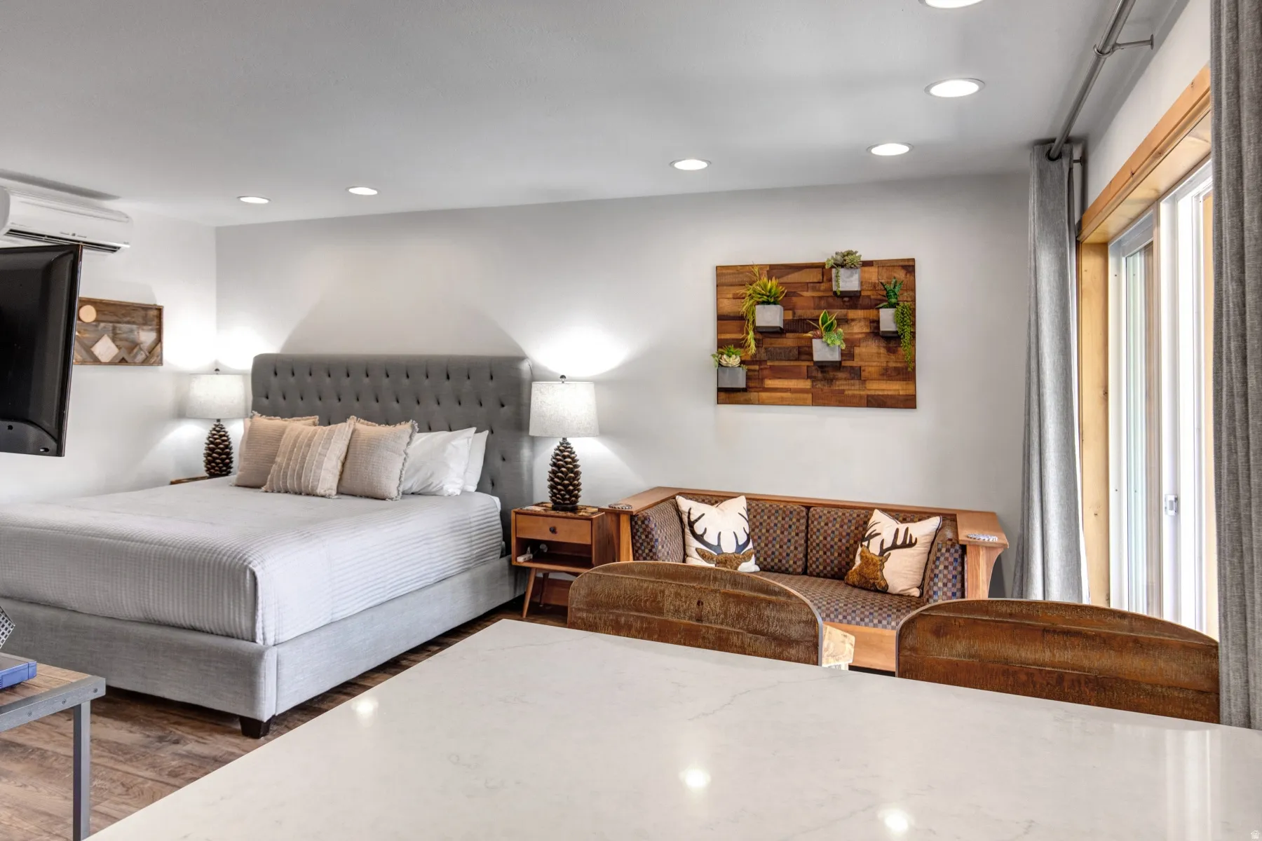 Bedroom featuring recessed lighting, wood finished floors, and a wall mounted air conditioner
