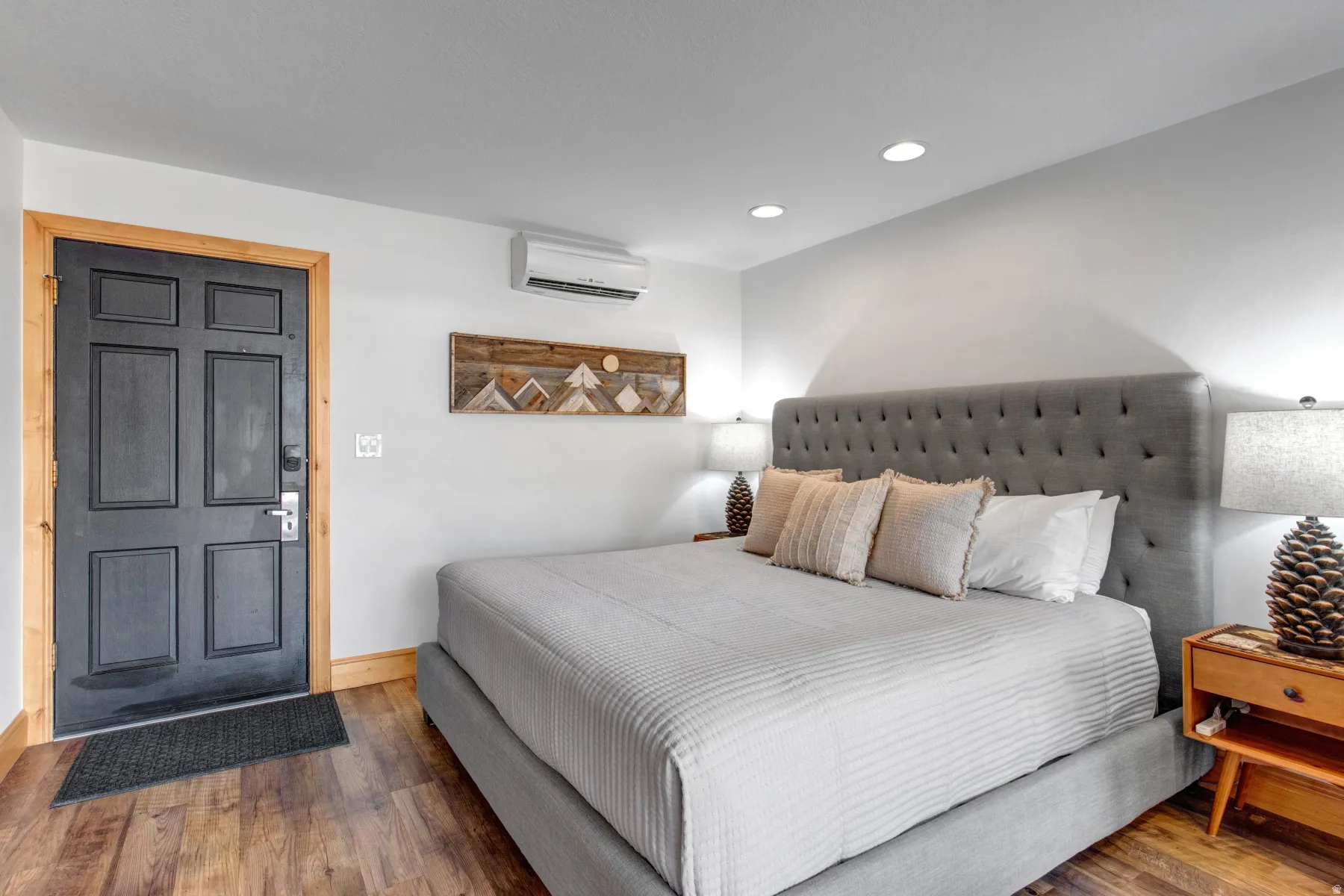 Bedroom featuring hardwood / wood-style flooring, recessed lighting, and a wall mounted AC