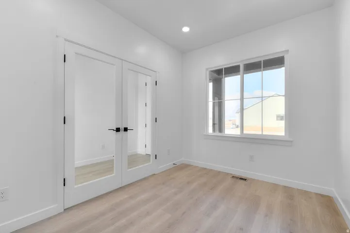 Unfurnished bedroom featuring a closet, light wood-type flooring, and recessed lighting