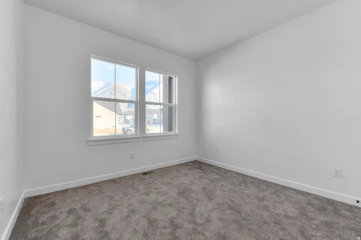 Carpeted empty room with baseboards