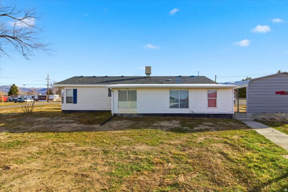 Back of house with a lawn
