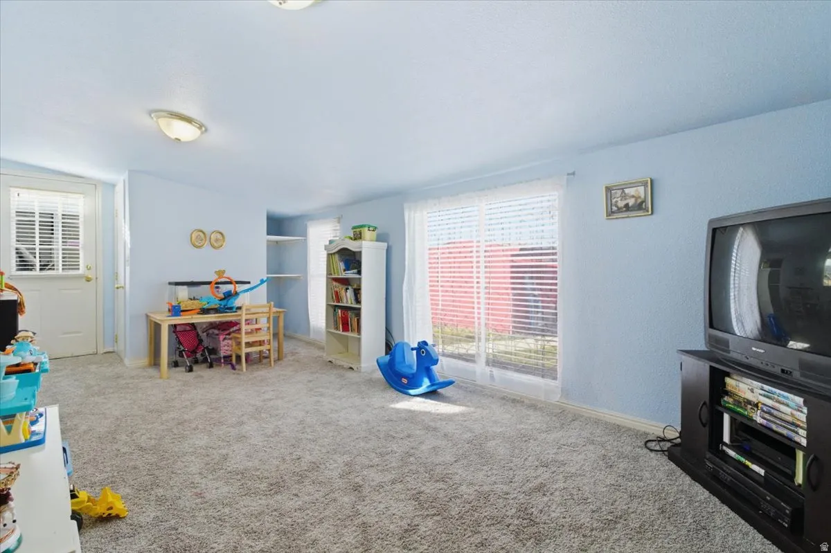 Rec room featuring carpet floors and baseboards