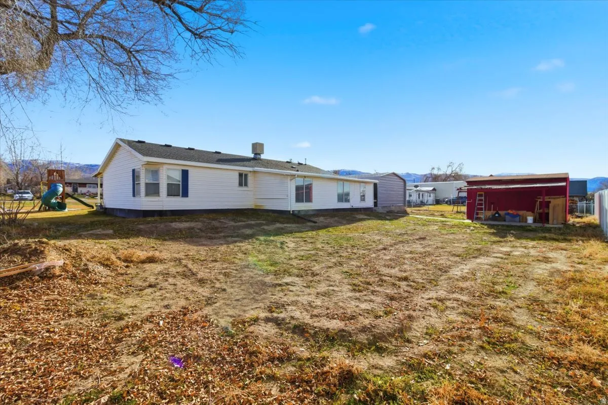 Back of property featuring an outdoor structure
