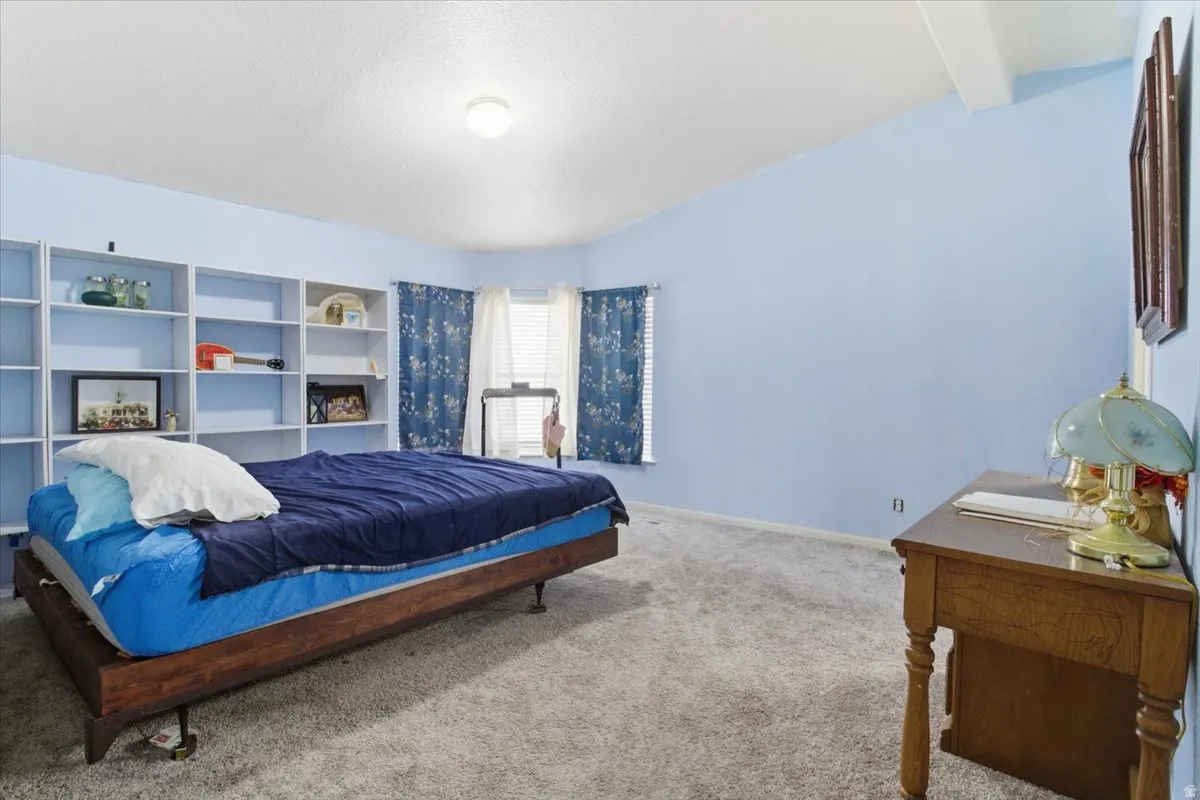 Carpeted bedroom with baseboards