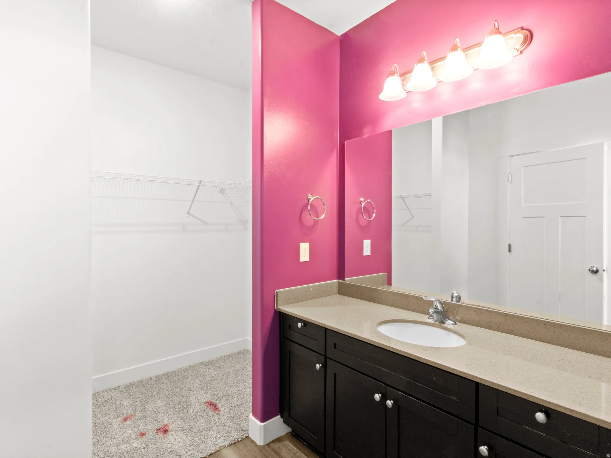 Full bath with a spacious closet and vanity