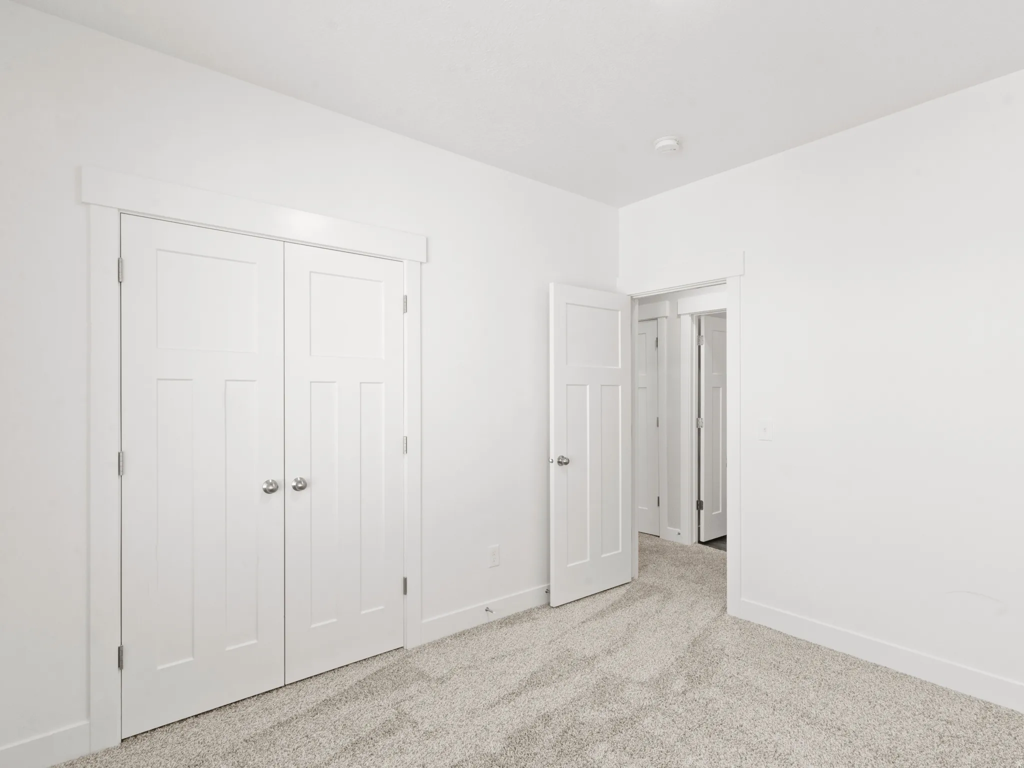 Unfurnished bedroom with carpet and a closet