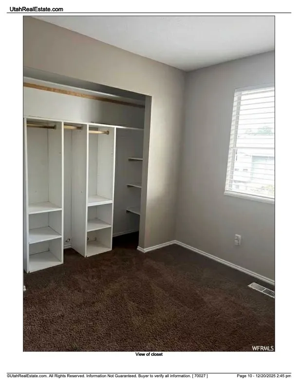 Unfurnished bedroom featuring dark colored carpet and a closet