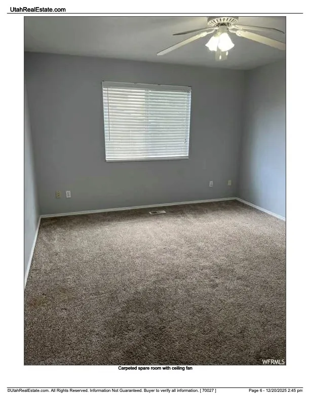 Spare room featuring carpet floors and ceiling fan