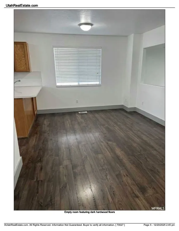 Unfurnished dining area featuring dark wood-style floors and baseboards