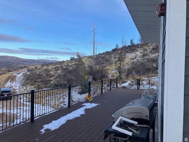 Snow covered deck with area for grilling