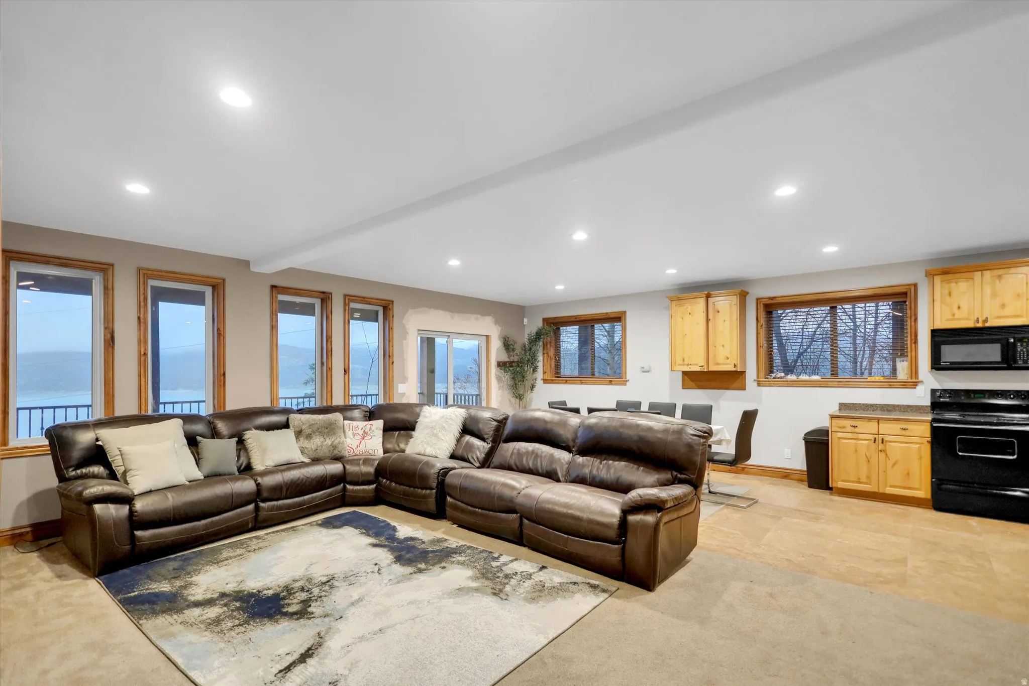 Living room with recessed lighting, beamed ceiling, and light colored carpet