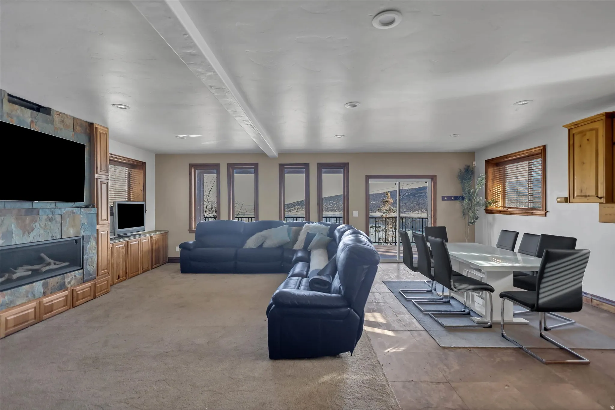 Living room with a large fireplace and beamed ceiling