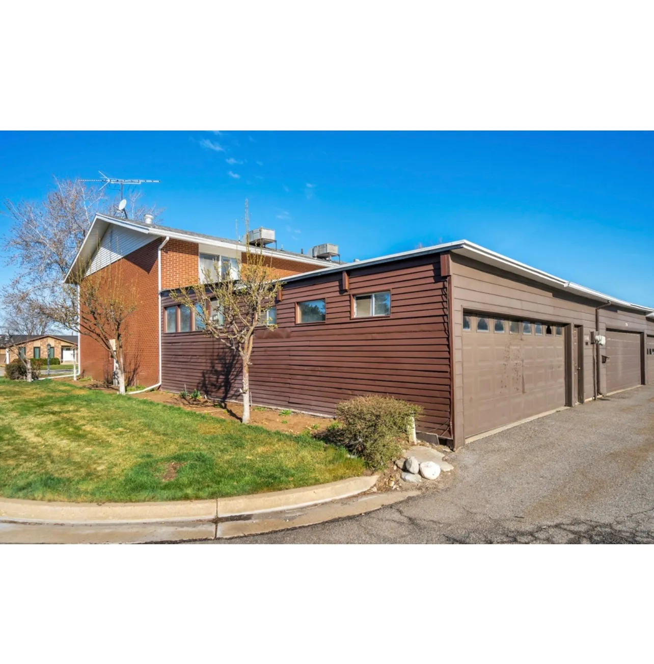 View of front of property with a garage and a front lawn