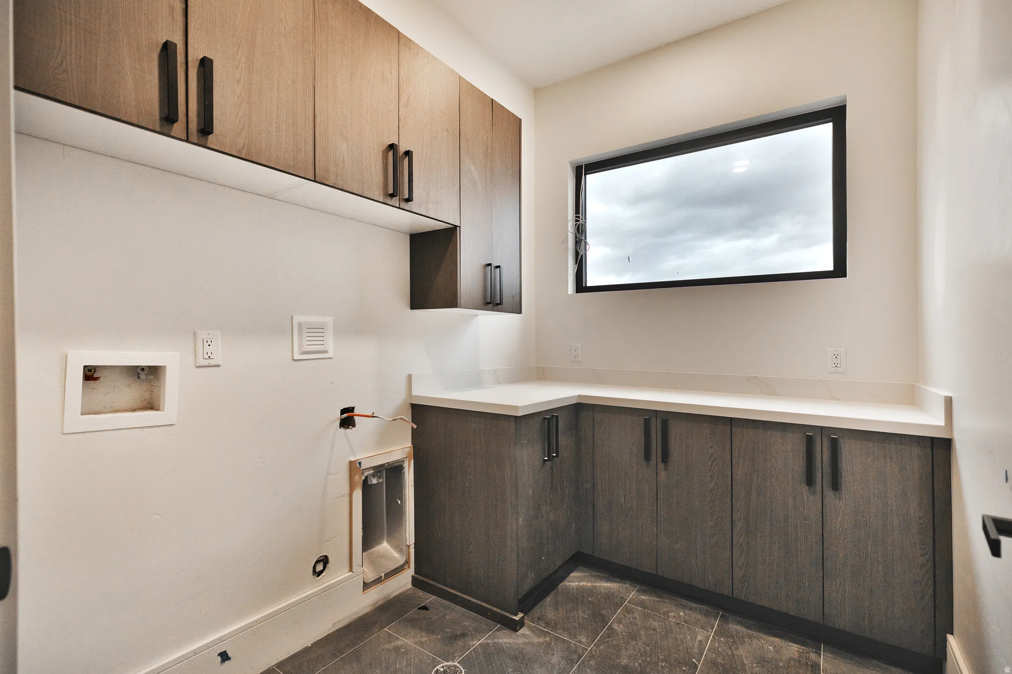Laundry room featuring washer hookup and cabinet space