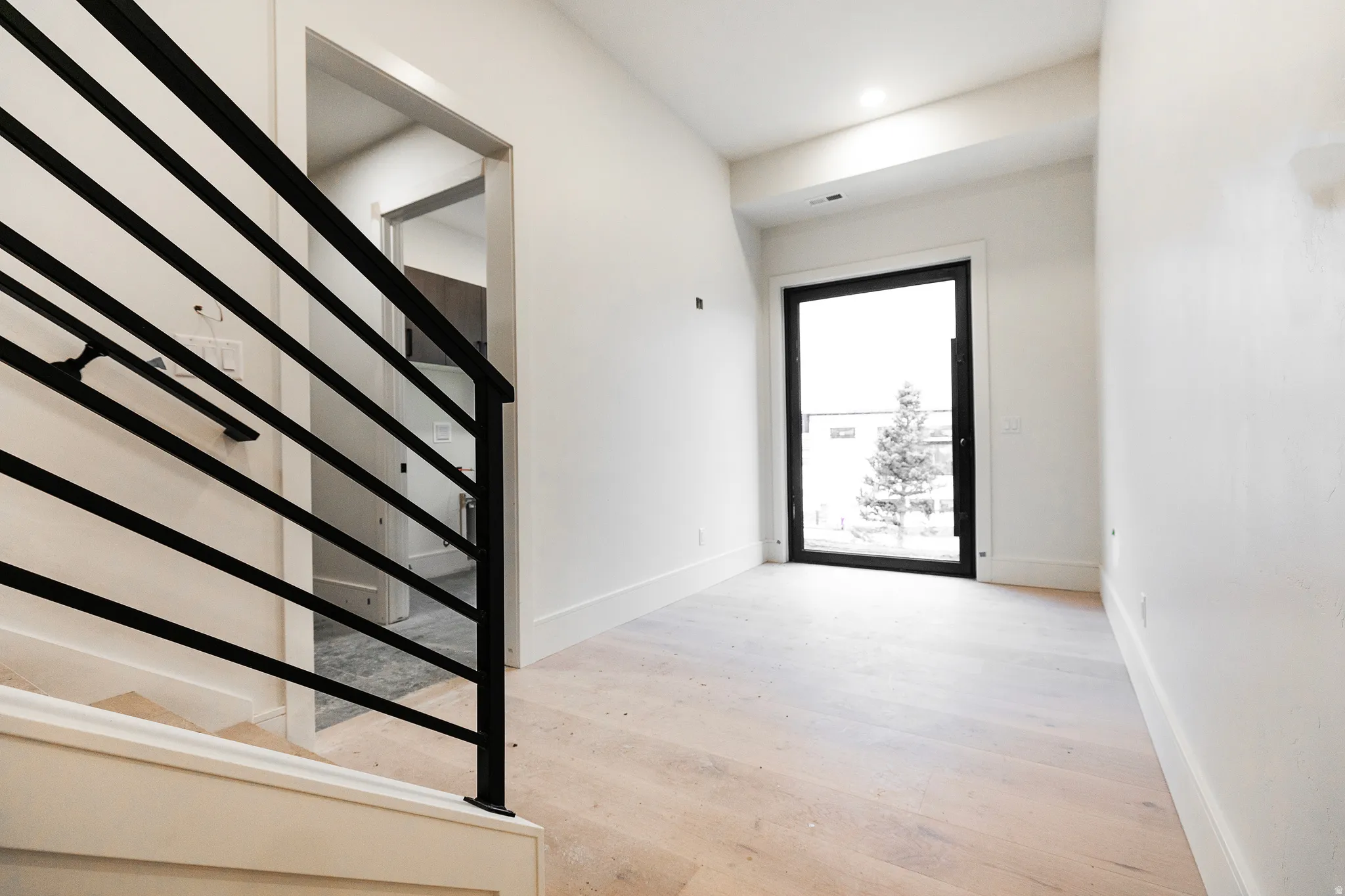 Entryway featuring light wood-style floors and large entry door