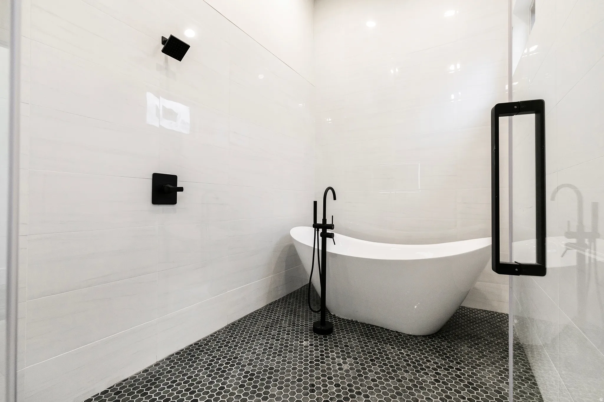 Bathroom featuring a freestanding bath, tile walls, and tile patterned flooring