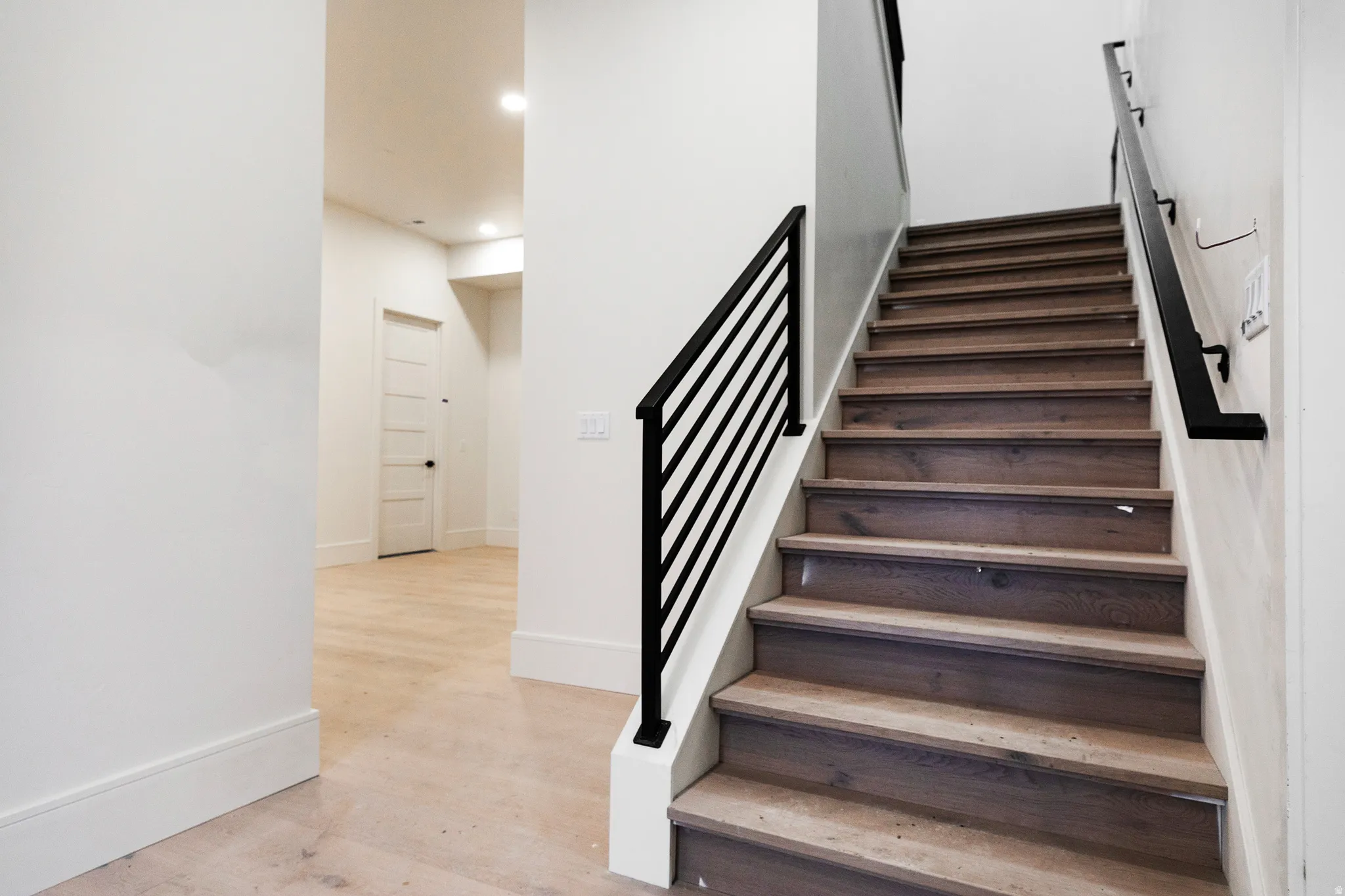 Entry/stairway with baseboards and wood finished floors