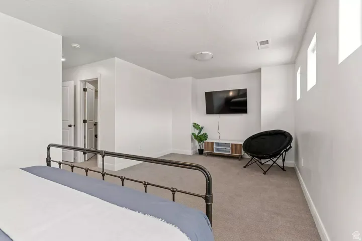 Carpeted bedroom with baseboards