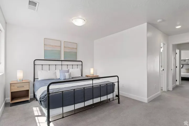 Carpeted bedroom featuring baseboards