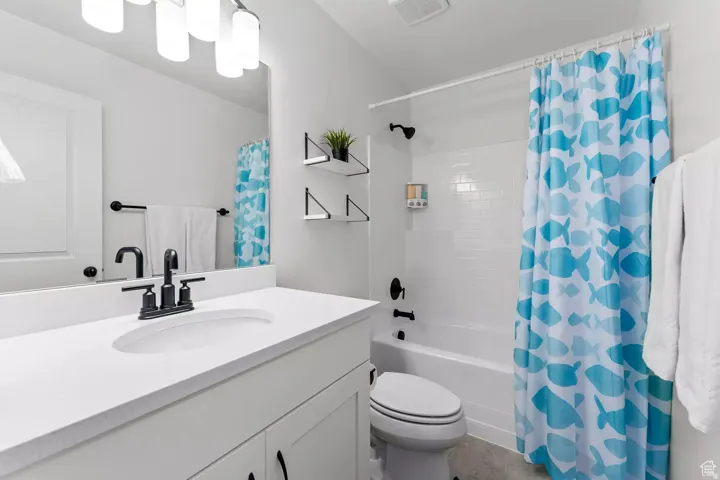 Full bath featuring vanity and shower / bath combo