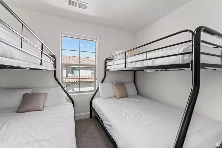 Bedroom with baseboards and dark colored carpet