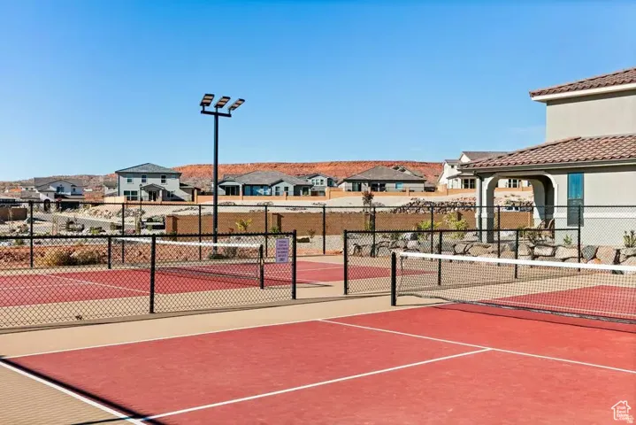 View of tennis court featuring a residential view