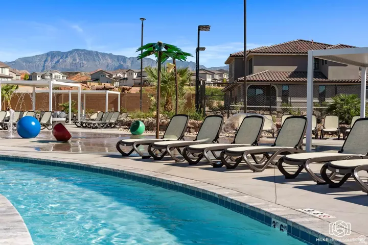 Community pool with a patio area, a residential view, and a mountain view