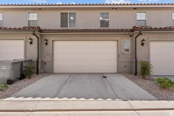 Mediterranean / spanish house featuring stucco siding, concrete driveway, and a garage