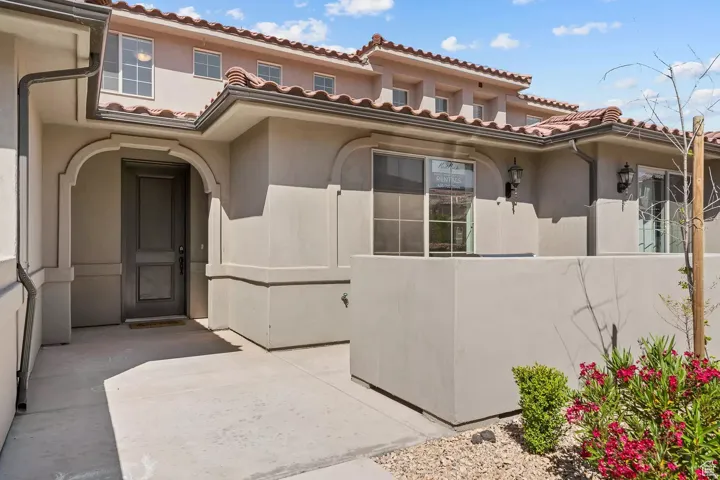 View of exterior entry featuring stucco siding and a tiled roof