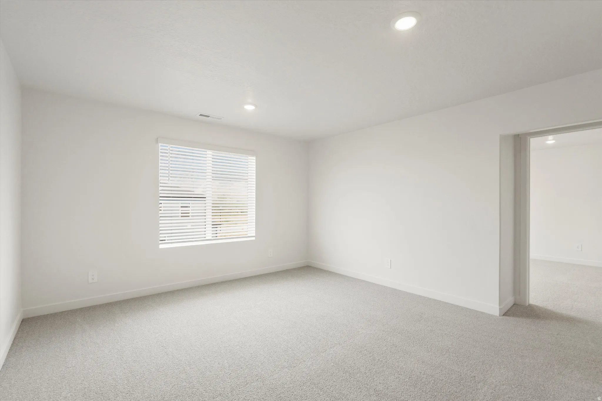 **DISCLAIMER** Interior colors & finishes may vary.Empty room featuring light colored carpet and recessed lighting