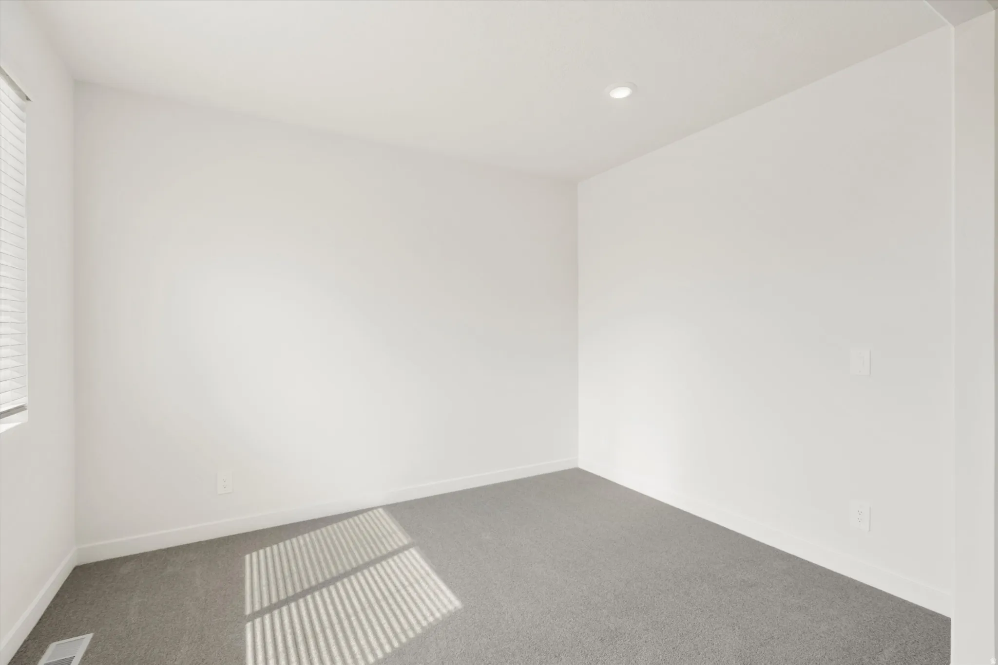 **DISCLAIMER** Interior colors & finishes may vary.Unfurnished room featuring carpet and recessed lighting