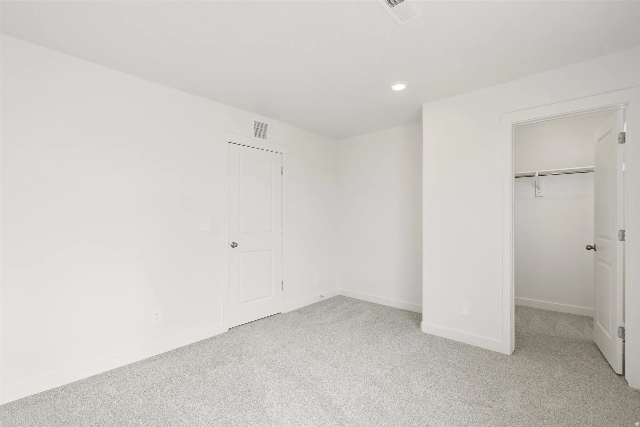 **DISCLAIMER** Interior colors & finishes may vary.Unfurnished bedroom with a spacious closet, light colored carpet, and recessed lighting