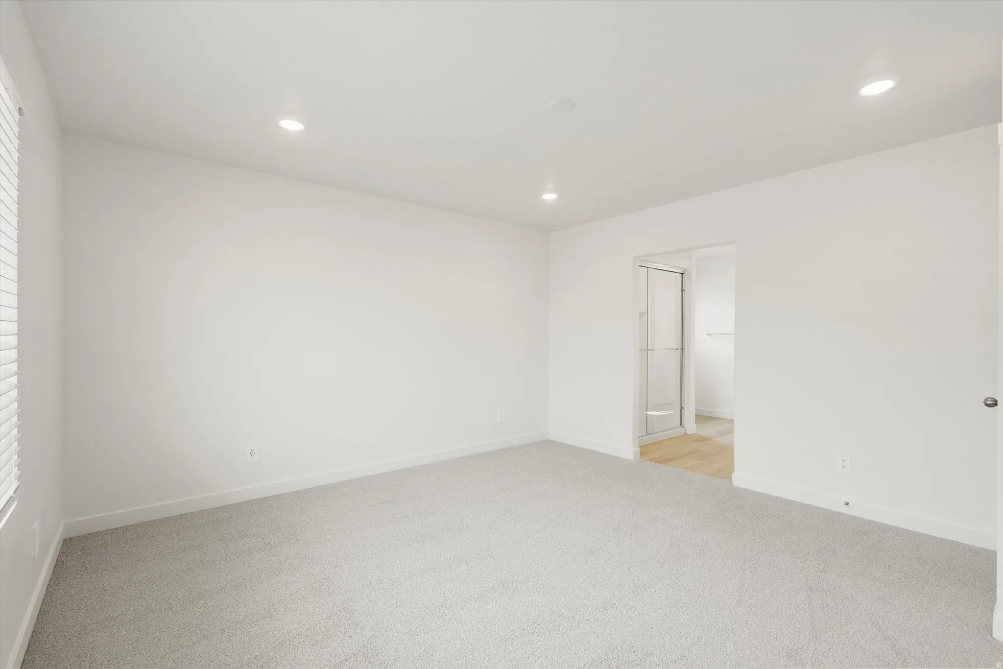 **DISCLAIMER** Interior colors & finishes may vary.Empty room with light colored carpet and recessed lighting