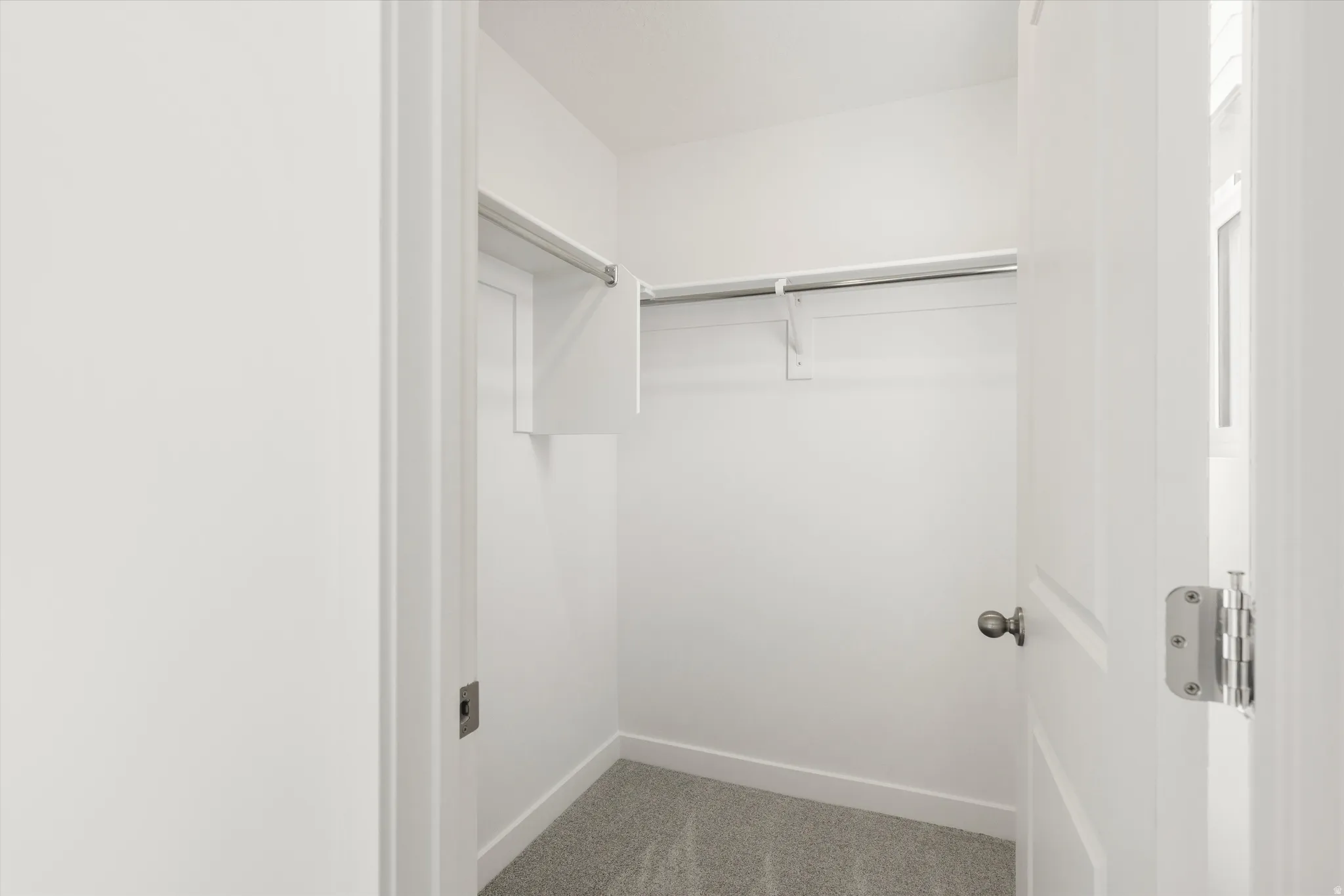**DISCLAIMER** Interior colors & finishes may vary.Spacious closet with light colored carpet