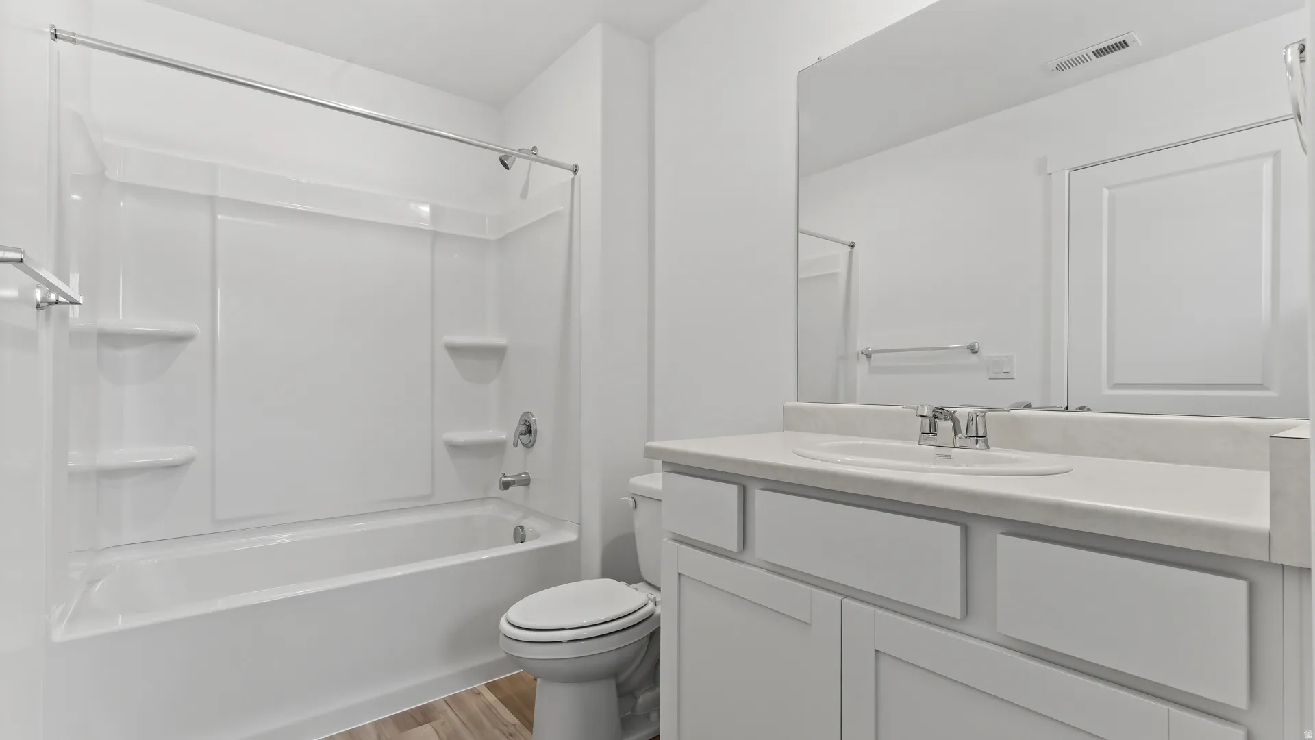 White bathroom featuring a full tub/shower combination with integrated shelving