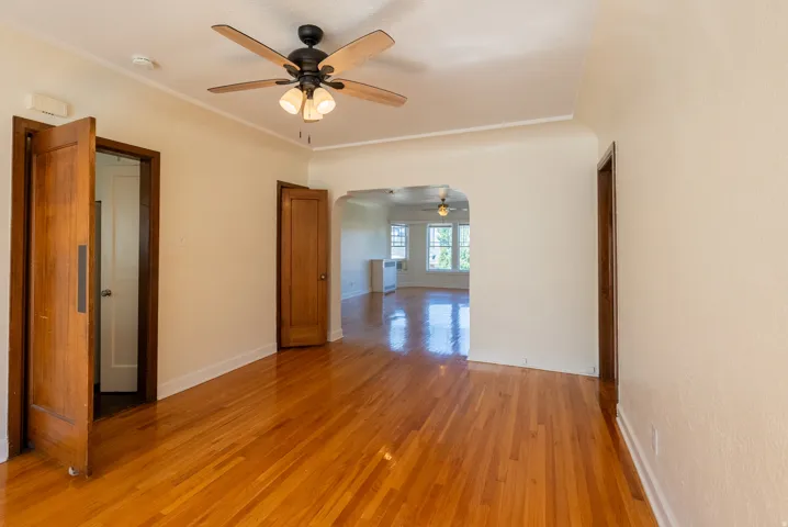 Hardwood flooring throughout, featuring a ceiling fan with integrated lighting