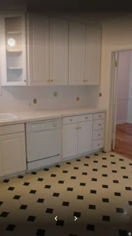 Apt # 5 > Kitchen featuring white dishwasher, white cabinetry, light countertops, and light floors