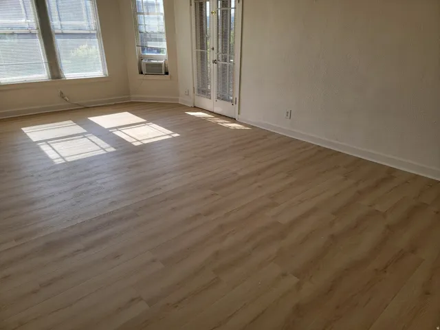 Apt # 9 >  Empty room with wood finished floors and baseboards