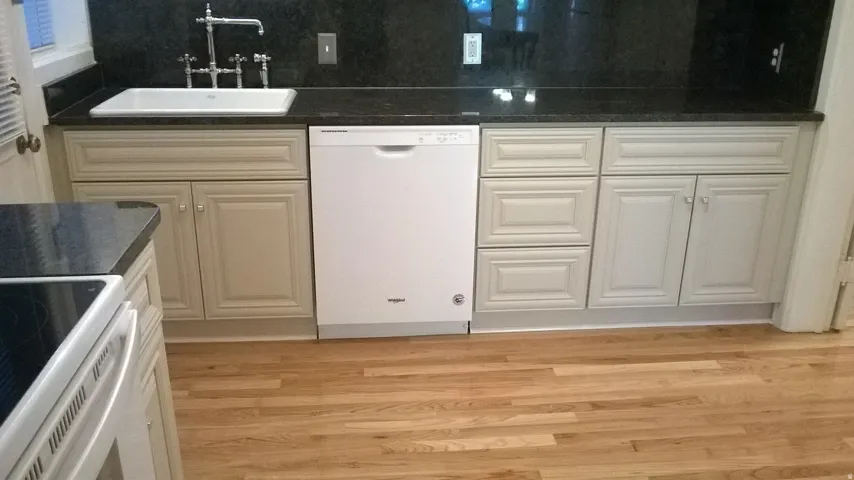 Apt # 1 Kitchen with dark countertops, white appliances, light wood-type flooring, and radiator